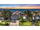 Beautiful single-story home with tropical landscaping and sunset water views at 12905 N Marsh Dr, Port Charlotte, FL 33953