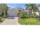 Charming home with a well-manicured lawn and a paved driveway, creating great curb appeal at 12905 N Marsh Dr, Port Charlotte, FL 33953