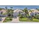 Beautiful property with mature palm trees, lush landscaping, and a picturesque view of the water at 12905 N Marsh Dr, Port Charlotte, FL 33953