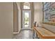 Inviting foyer featuring neutral paint, tile flooring, and an arched doorway leading to the rest of the home at 12905 N Marsh Dr, Port Charlotte, FL 33953