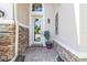 Welcoming front porch showcasing a decorative stone accent wall and a stylishly framed glass door at 12905 N Marsh Dr, Port Charlotte, FL 33953