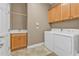 A clean laundry room boasts ample cabinet space, a sink with modern fixtures, and efficient washer and dryer at 12905 N Marsh Dr, Port Charlotte, FL 33953