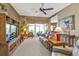 Spacious living room with ceiling fan and views of the outdoor lanai at 12905 N Marsh Dr, Port Charlotte, FL 33953