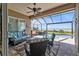 Relaxing screened-in patio with comfortable seating, ceiling fan, and serene waterfront views at 12905 N Marsh Dr, Port Charlotte, FL 33953