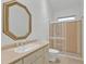 Well-lit bathroom with an octagonal mirror above the sink and a shower with translucent sliding glass doors at 13770 Palmetto Point Ct, Port Charlotte, FL 33953