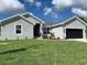 Charming single-story home with a well-manicured lawn, a two car garage, and a welcoming front entrance at 13902 Allamanda Cir, Port Charlotte, FL 33981