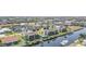 Aerial view showcasing the home's waterfront location with private dock and community pool at 1423 Mediterranean Dr # C, Punta Gorda, FL 33950