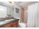 Functional bathroom featuring granite counters, decorative mirror and a combined shower tub at 1423 Mediterranean Dr # C, Punta Gorda, FL 33950