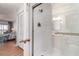 Bathroom shower featuring new shower head, glass door, and built in hand rail at 1423 Mediterranean Dr # C, Punta Gorda, FL 33950