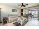 Comfortable living area with neutral tones, stylish furnishings, and a sliding glass door to balcony at 1423 Mediterranean Dr # C, Punta Gorda, FL 33950