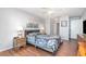 Comfortable main bedroom with a ceiling fan, art, and a beautifully patterned duvet on the bed at 1423 Mediterranean Dr # C, Punta Gorda, FL 33950