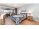 Bright main bedroom with private balcony access and wood-look floors at 1423 Mediterranean Dr # C, Punta Gorda, FL 33950