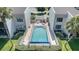 Community pool surrounded by lush landscaping and a privacy fence, offering a serene retreat at 1423 Mediterranean Dr # C, Punta Gorda, FL 33950