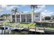 Condo's outdoor space with dock, landscaping, and waterfront view at 1423 Mediterranean Dr # C, Punta Gorda, FL 33950
