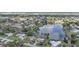 Aerial view of a dense neighborhood and waterfront homes alongside a large lake at 1430 Aken St, Port Charlotte, FL 33952