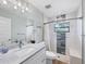 Modern bathroom featuring a vanity with marble countertop, tiled shower with bench, and stylish fixtures at 14325 Mcfarland Ave, Port Charlotte, FL 33981