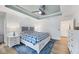 A spacious bedroom featuring wood floors, stylish ceiling fan, and a comfortable bed with blue accents at 14325 Mcfarland Ave, Port Charlotte, FL 33981