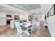 Well-lit dining area and kitchen showcasing hardwood floors and an open-concept design for comfortable living at 14325 Mcfarland Ave, Port Charlotte, FL 33981
