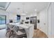 Modern kitchen with white cabinetry, stainless steel appliances, and a marble island with barstool seating at 14325 Mcfarland Ave, Port Charlotte, FL 33981