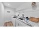 Convenient laundry area with modern appliances, sink, marble countertops, and ample storage space at 14325 Mcfarland Ave, Port Charlotte, FL 33981