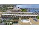 Expansive aerial view of the community with tropical landscaping, pool, parking, and stunning waterfront views at 150 Harborside Ave # 304, Punta Gorda, FL 33950