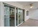A relaxing tiled balcony with sliding glass doors and a ceiling fan at 150 Harborside Ave # 304, Punta Gorda, FL 33950