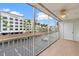 Screened condo balcony with parking lot and hotel view with white ceiling fan at 150 Harborside Ave # 304, Punta Gorda, FL 33950