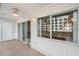 Spacious tiled balcony featuring a ceiling fan, white walls and balcony access door at 150 Harborside Ave # 304, Punta Gorda, FL 33950
