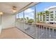 Screened condo balcony with white railings and a view of parking at 150 Harborside Ave # 304, Punta Gorda, FL 33950