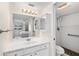 Bathroom with white cabinets and shower, reflecting the bedroom, creating a seamless and serene space at 150 Harborside Ave # 304, Punta Gorda, FL 33950