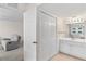 Bedroom with a view into bathroom and includes recliner seating area for added convenience and relaxation at 150 Harborside Ave # 304, Punta Gorda, FL 33950