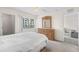 Well-lit bedroom boasts a large window, light wood dresser, and access to additional rooms for convenience at 150 Harborside Ave # 304, Punta Gorda, FL 33950