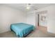 Cozy bedroom with ensuite bathroom, featuring a ceiling fan and neutral walls for a peaceful ambiance at 150 Harborside Ave # 304, Punta Gorda, FL 33950