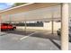 Assigned covered parking area with a red truck and silver SUV at 150 Harborside Ave # 304, Punta Gorda, FL 33950