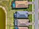 Overhead view showcasing backyard pools, screened lanais and serene lake views at 15033 Spanish Point Dr, Port Charlotte, FL 33981