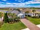 Aerial view of a beautiful single-story home that overlooks a scenic pond in a well-maintained community at 15033 Spanish Point Dr, Port Charlotte, FL 33981