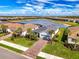 Aerial view of a beautiful single-story home that overlooks a scenic pond in a well-maintained community at 15033 Spanish Point Dr, Port Charlotte, FL 33981