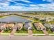 Aerial view of a beautiful single-story home that overlooks a scenic pond in a well-maintained community at 15033 Spanish Point Dr, Port Charlotte, FL 33981