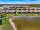 Aerial view of a beautiful community with lakefront homes featuring screened lanais at 15033 Spanish Point Dr, Port Charlotte, FL 33981