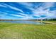 Spacious backyard overlooking a tranquil lake, perfect for relaxation and outdoor activities at 15033 Spanish Point Dr, Port Charlotte, FL 33981