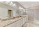 Bathroom featuring double sinks, granite countertops and glass-enclosed shower at 15033 Spanish Point Dr, Port Charlotte, FL 33981