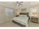 Comfortable bedroom with a ceiling fan and natural light at 15033 Spanish Point Dr, Port Charlotte, FL 33981