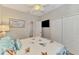 Comfortable bedroom with a ceiling fan, closet, and soft lighting, designed for relaxation and rest at 15033 Spanish Point Dr, Port Charlotte, FL 33981