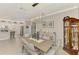 Open dining room with modern chandelier flows to the kitchen and living areas at 15033 Spanish Point Dr, Port Charlotte, FL 33981