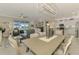 Open-concept dining room featuring a modern light fixture and seamless flow to the kitchen and living area at 15033 Spanish Point Dr, Port Charlotte, FL 33981