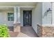 Close up of a beautiful front entrance and porch area with stone and brick accents at 15033 Spanish Point Dr, Port Charlotte, FL 33981