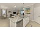 Kitchen island with granite countertops and stainless steel appliances flows into the living and dining areas at 15033 Spanish Point Dr, Port Charlotte, FL 33981