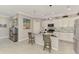 Modern kitchen with stainless steel appliances, white cabinets, and a center island with bar seating at 15033 Spanish Point Dr, Port Charlotte, FL 33981