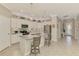 Stylish kitchen featuring white cabinetry, a center island, and views of the entryway at 15033 Spanish Point Dr, Port Charlotte, FL 33981