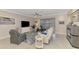 Comfortable living room with tile floors, ceiling fan, and stylish furnishings at 15033 Spanish Point Dr, Port Charlotte, FL 33981